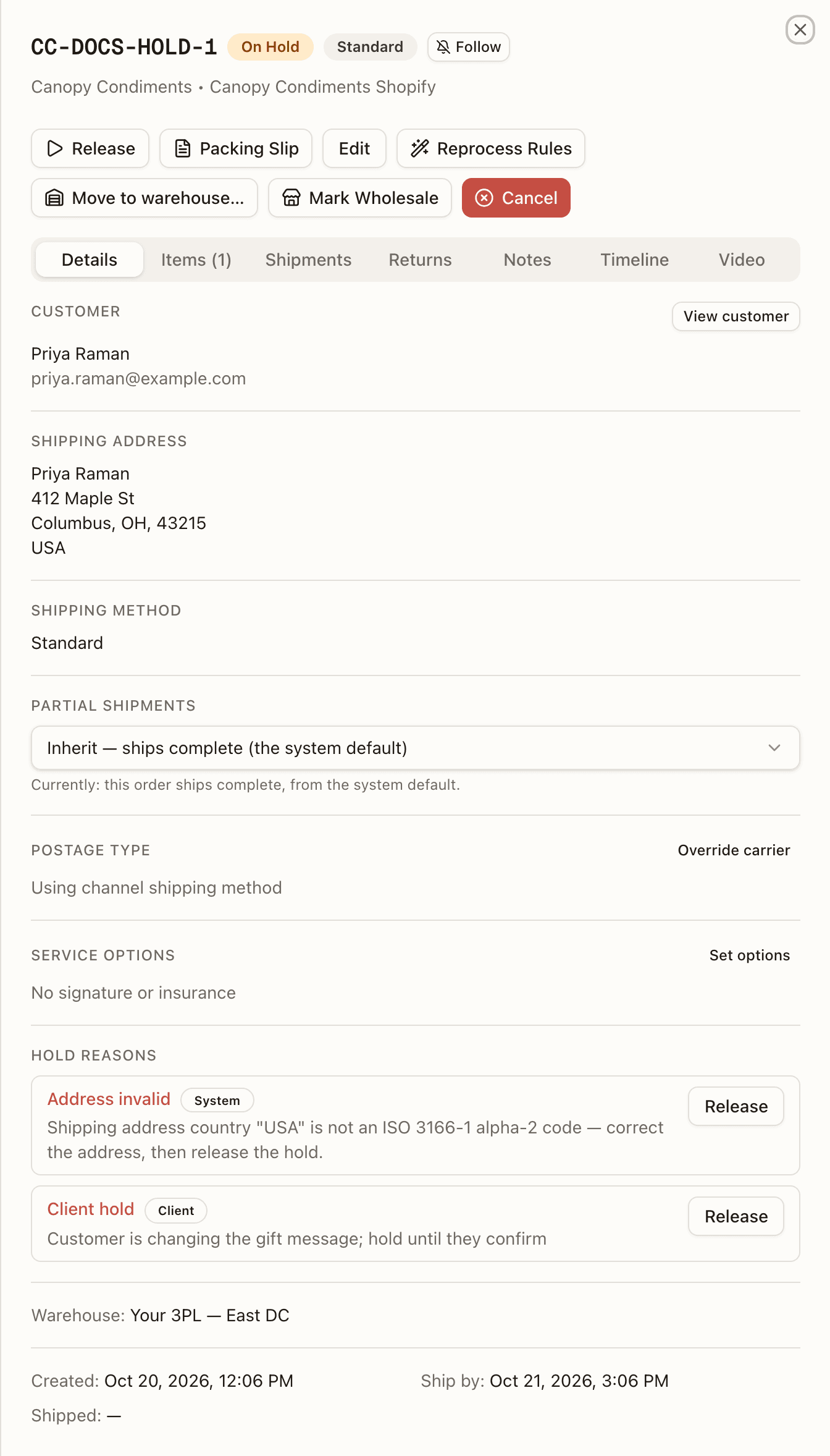 The hold list on an order's Details tab: the System's Address invalid hold above the brand's Client hold, each with its reason and its own Release